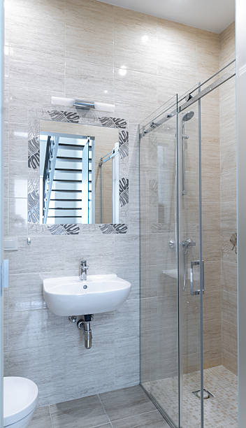 istock Elegant Modern Bathroom with Glass Shower and Wall-Mounted Sink 2251552561