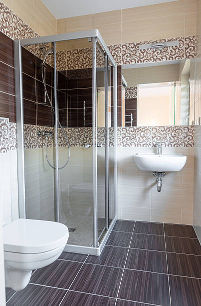 istock Modern Bathroom Interior with Glass Shower Cabin and Tiled Floor 2251552601