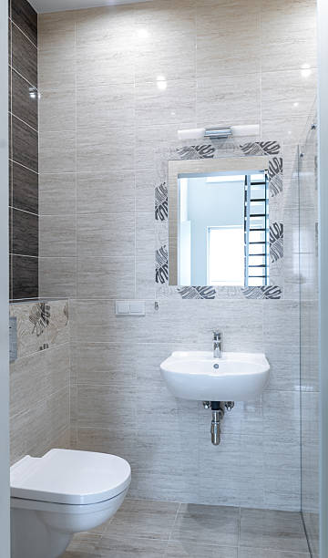 istock Elegant Modern Bathroom with Glass Shower and Wall-Mounted Sink 2251552627