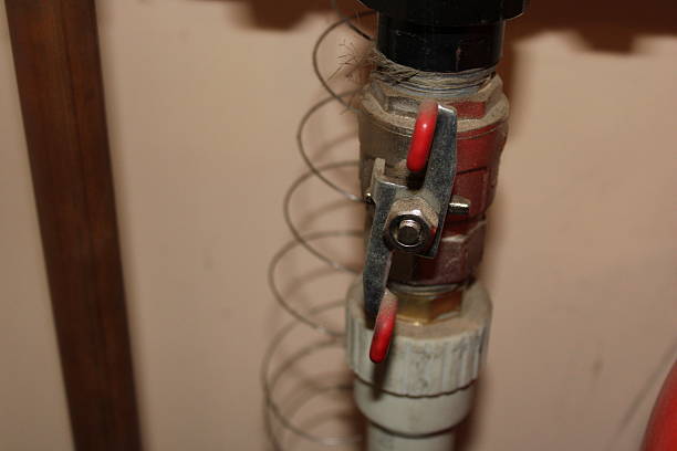 istock Valve with spring connected to pipe in a utility room during daylight hours 2251552689