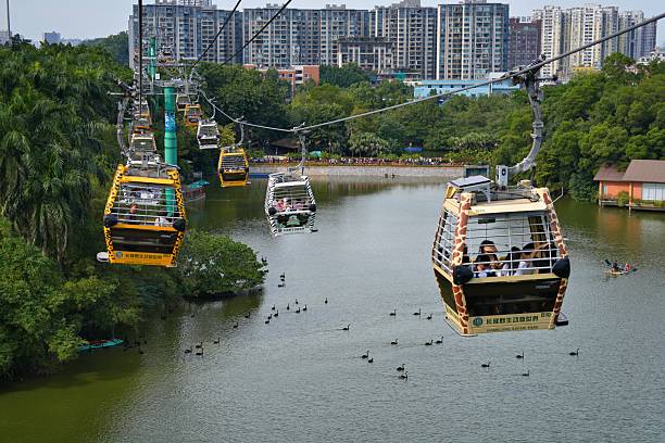 Tourists ride cable car in Chimelong Safari Park tourist attraction in Guangzhou city in Guangdong region of China.
