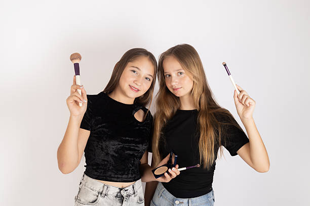 Two girls applying makeup and getting ready together for a night out.