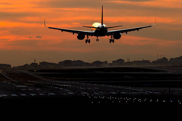 Passenger airplane landing at dusk