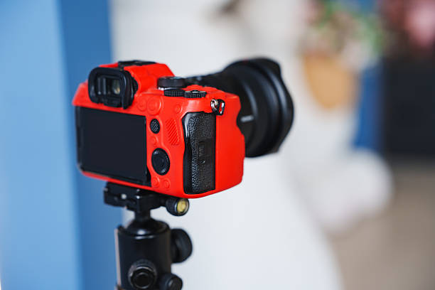 istock Vibrant red camera set on tripod for capturing moments 2251561791