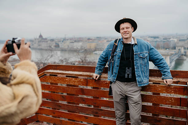 Tourists enjoying panoramic views over the Danube River and Pest skyline from the Buda side of the city