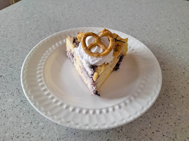 Tasty Blueberry Crumble Cheesecake with cream cheese,blueberries jam and pretzel on a plate. Dessert Menu.