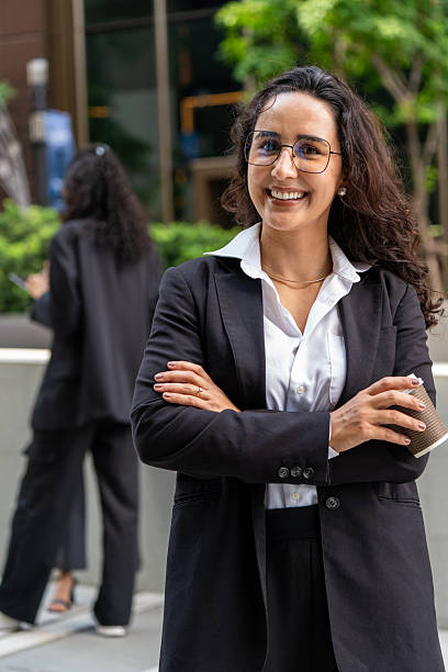 istock Three businesswomen talking and drinking coffee outdoors, showcasing teamwork, communication, and professional collaboration in a modern corporate environment. Ideal for business, leadership, and workplace concepts. 2251564482