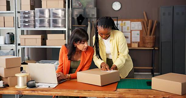 istock Label, team and women with laptop in office for box and ecommerce order confirmation. Tracking delivery, inventory and parcel information with people in small business for shipping and supply chain 2251565610