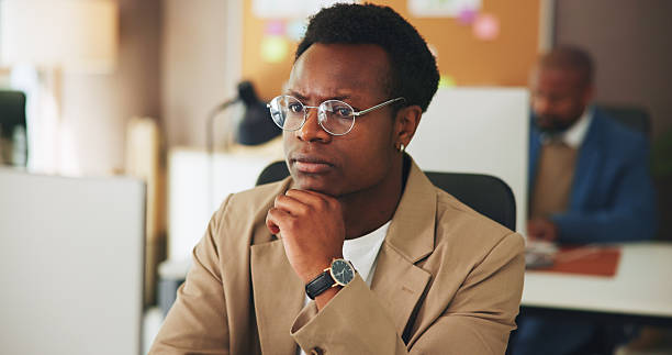istock Thinking, business man and computer for reading news article, grammar and insight on story angle. Coworking, editor or tech at publishing agency for proofreading investigative report or blog decision 2251566071