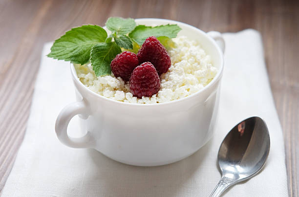 Time for breakfast. Cottage cheese with raspberries. Close up.