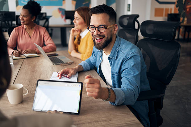 istock Smiling Team Engaging in Creative Office Meeting at Modern Workspace 2251567902