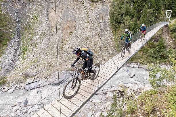 istock Group of mountainbiker on suspension bridge. 2251569149