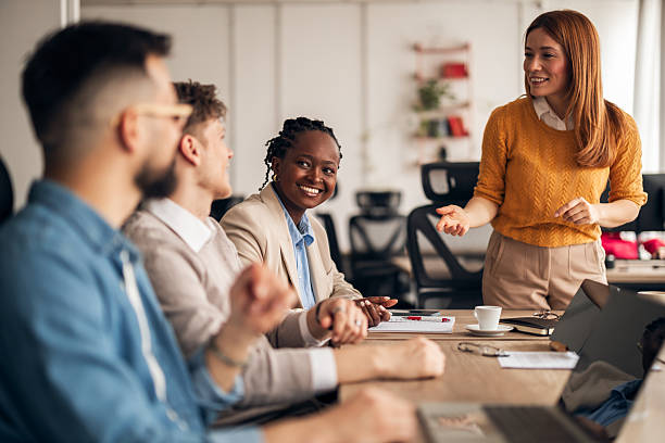 istock Group of Coworkers Having a Discussion in a Bright Office Environment 2251569197
