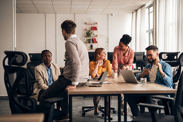 istock Group of Colleagues Collaborating in a Modern Office Setting 2251569198
