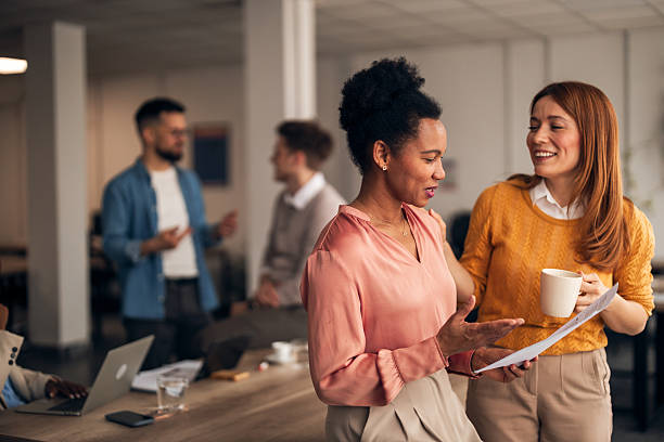istock Colleagues Engaging During Coffee Break in Modern Office Environment 2251569336