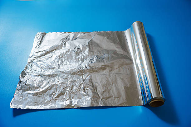 istock A roll of baking foil on a blue background. 2251573210