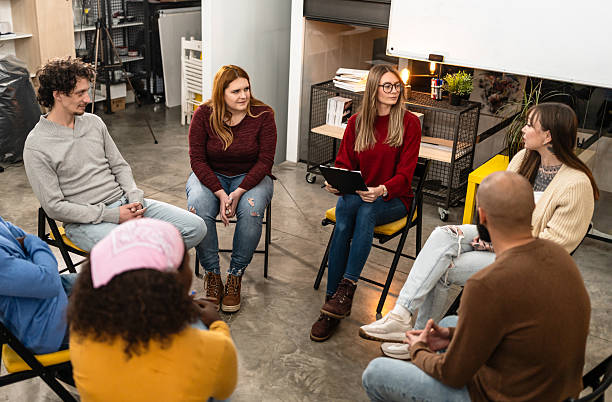 istock Diverse adults participating in group therapy discussion session 2251574393