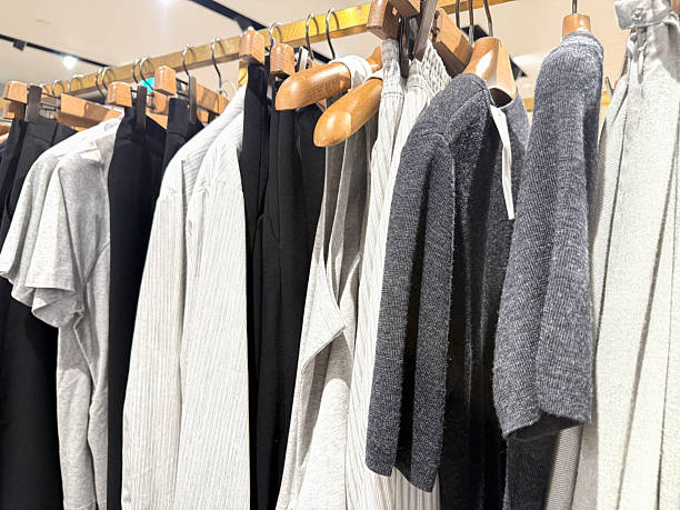 istock Gray and white sweaters and shirts on clothing stand. 2251574872