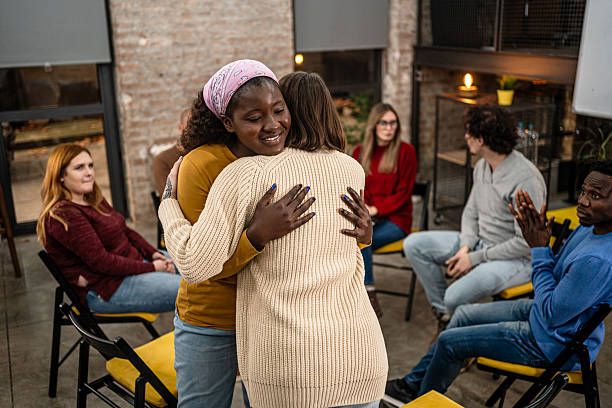 istock People hugging during support group meeting in therapy 2251576286