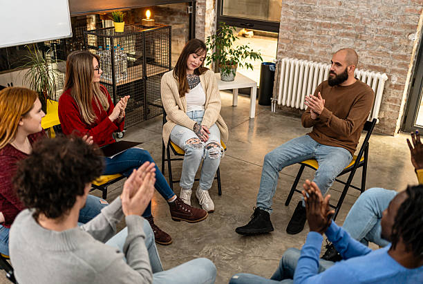 istock Support group applauding woman sharing story 2251576738