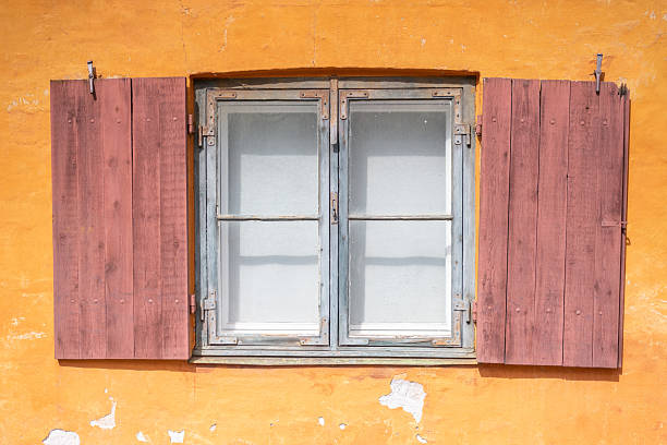istock A window with wooden shutters and an orange wall 2251578936