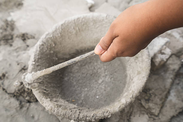 hands  carrying a bucket of cement