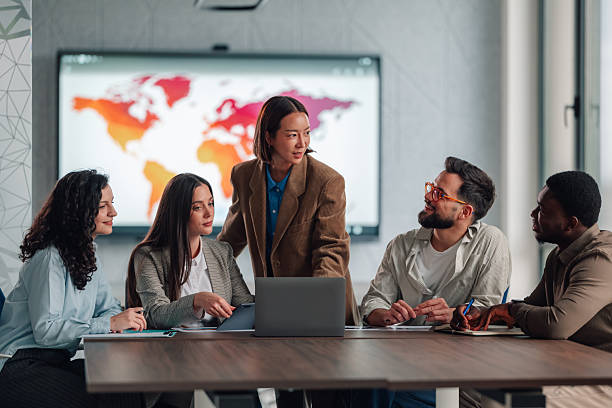 istock Diverse business team collaborating during meeting with global map 2251584316