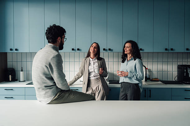 istock Business colleagues having coffee break in office kitchen 2251584425