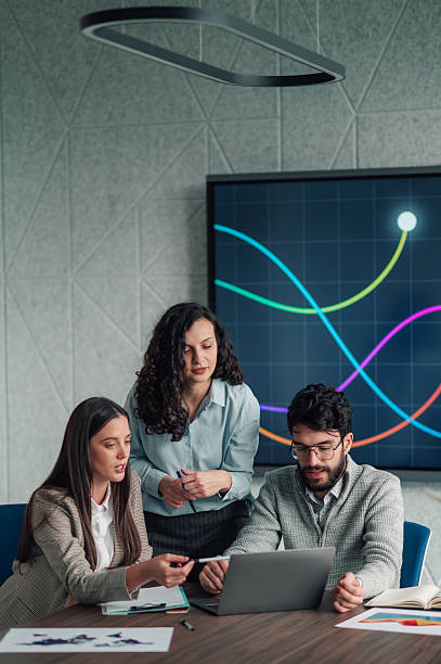 istock Business professionals analyzing data in modern office meeting 2251584508