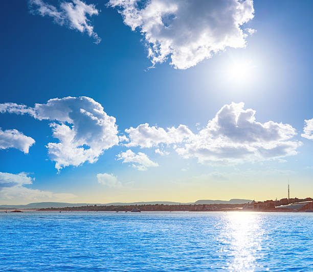 Sunny summer view across the Oslofjord from Akershusstranda in Oslo Norway with calm blue sea and distant coastline