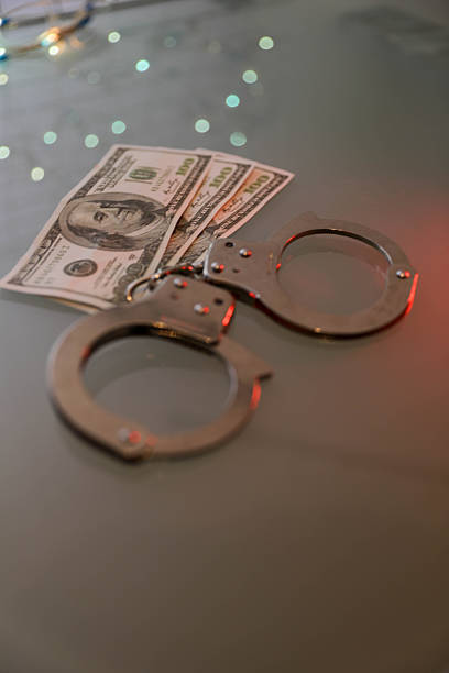 A man holding a gun and a dollar bill. The image is a commentary on the value of money and the power of guns