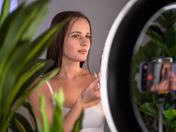 istock Woman Streaming Video Content Indoors with Ring Light 2251590368