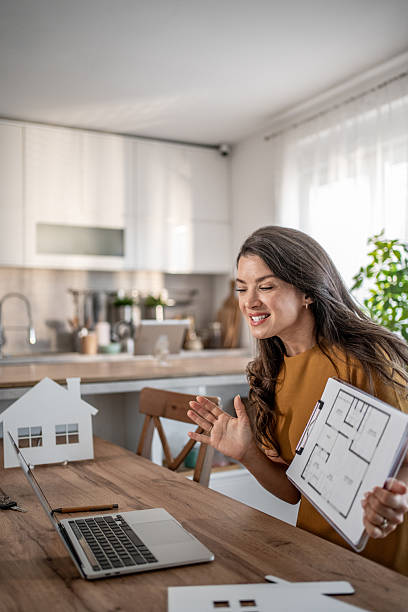 istock Real estate agent having virtual meeting discussing floor plan 2251590745