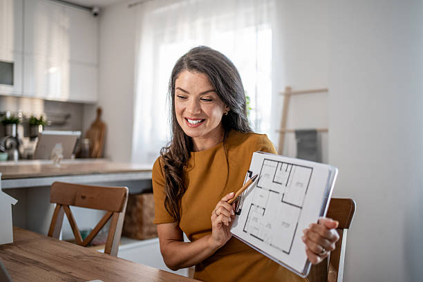 istock Real estate agent discussing blueprint on video call 2251590847