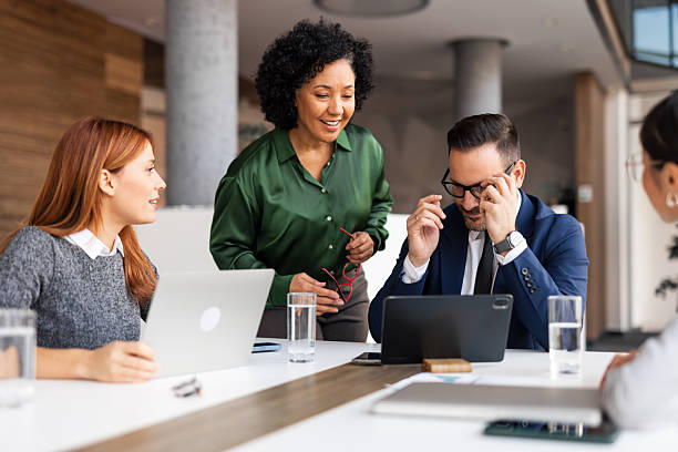 istock Team Collaboration in a Modern Office Space with Laptops and Digital Devices 2251596365