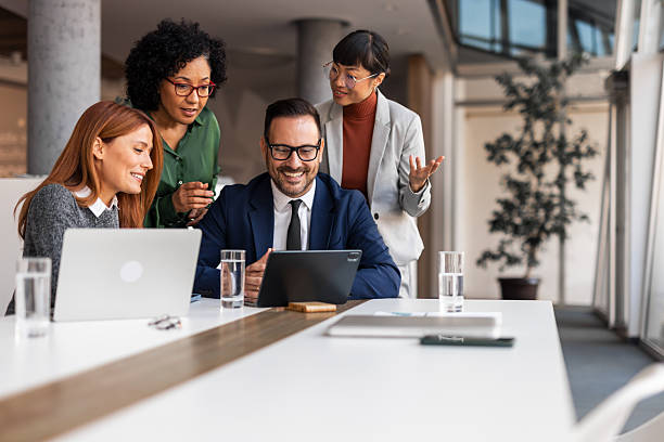 istock Group of Colleagues Collaborating in a Modern Office Environment 2251596416