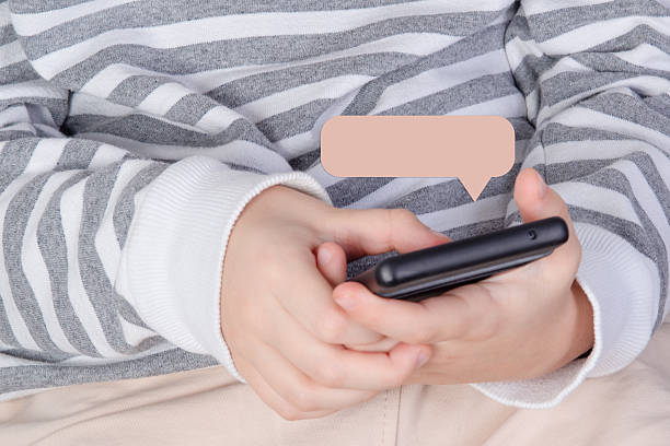istock Close-up hands-and-smartphone photo with editable message popup, realistic layout for mobile interaction mockups. 2251597665
