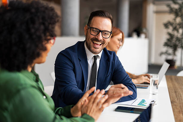 istock Smiling Business Professionals Engaged in a Productive Office Discussion 2251597697