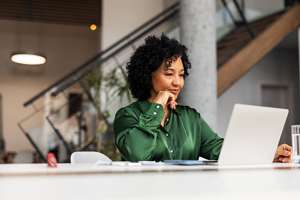 istock Professional Woman Working on Laptop in Modern Office Setting 2251598490