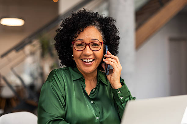 istock Smiling Professional on a Phone Call in a Modern Workspace 2251598679