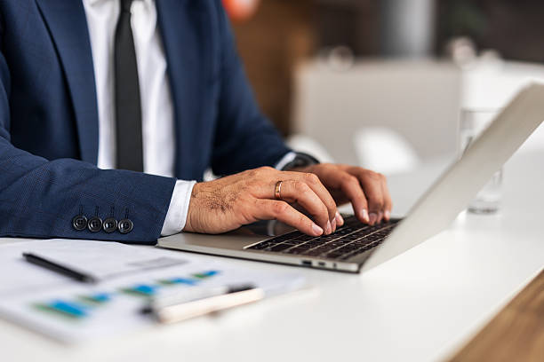 istock Businessman Typing on Laptop at Office Desk 2251599275