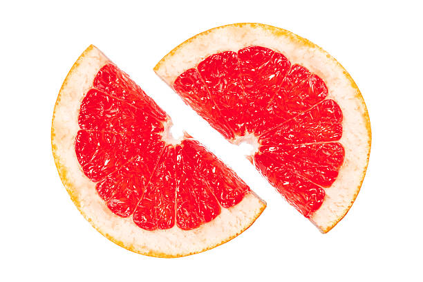 istock A slice of grapefruit is cut in half, revealing its juicy red interior 2251600162