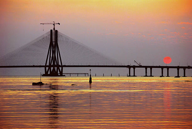 istock Sun dips behind Bandra-Worli Sea Link, also called Rajiv Gandhi Sea Link. It is a cable-stayed vehicular bridge over Arabian sea that links Bandra in north Mumbai with Worli in South Mumbai considerably shortening the travelling time and distance. 2251603567
