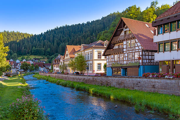 Scenic view of Schiltach river with historic half timbered houses and flowers in Black Forest Germany