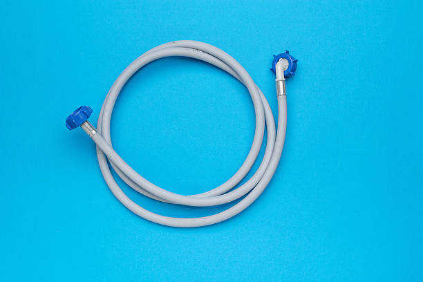 istock Flexible Hose with Blue Connectors on Bright Blue Background 2251607311