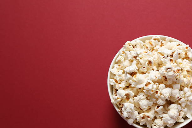 istock Popcorn in a bowl on color background 2251608079