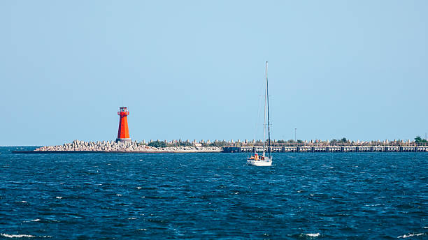 istock Sailboat and Lighthouse 2251610150