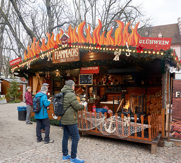 Basel, Switzerland - December 10, 2025: People stroll through the old town, home to the city’s two charming Christmas markets, as locals and tourists enjoy the festive season.