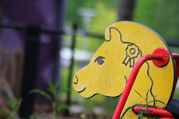 A yellow horse rode at a park