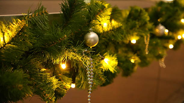 istock Christmas tree decoration, a Christmas tree branch with a luminous garland 2251615654
